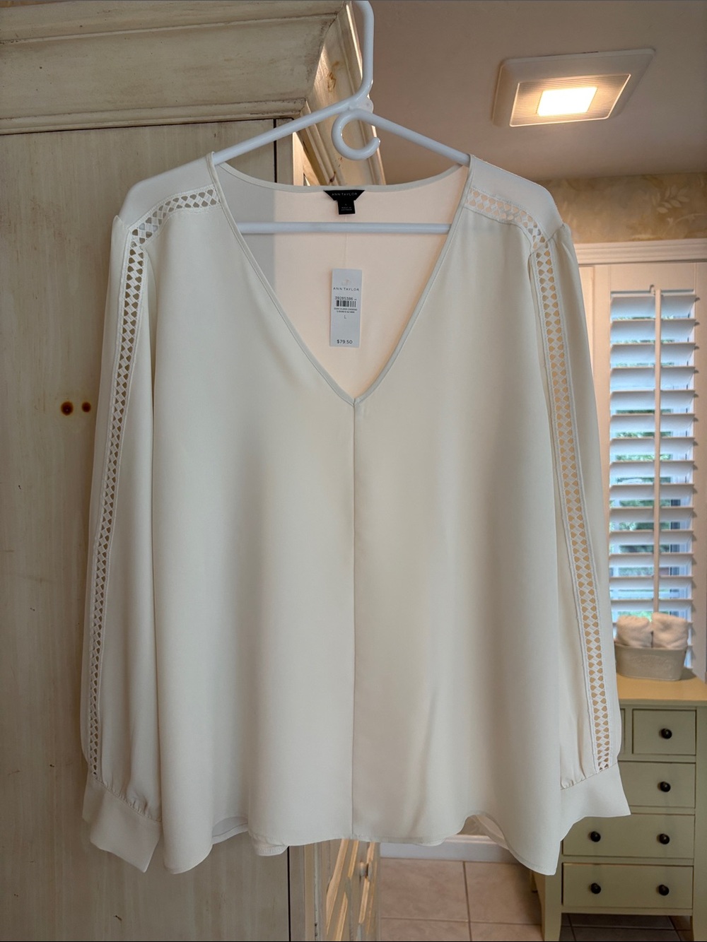 Ann Taylor Cream V-Neck Long Sleeve Blouse with Open Eyelet Trim Along Sleeve.